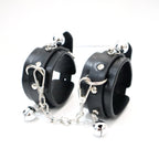 Black PU wrist cuffs with silver-tone bells and detachable chain