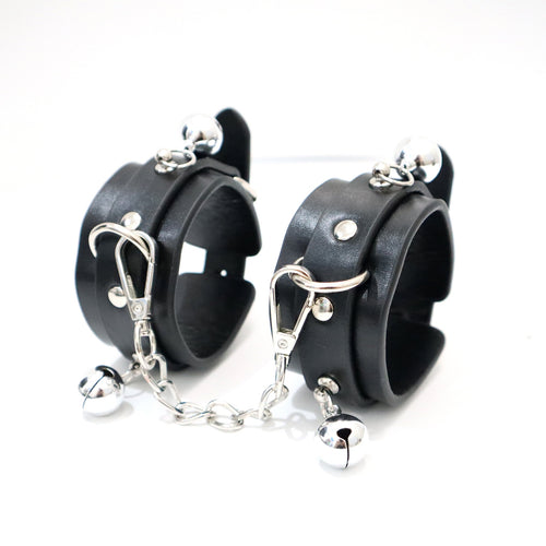 Black PU wrist cuffs with silver-tone bells and detachable chain